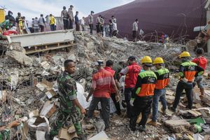 Indonesian authorities with volunteers searching earthquake victims during the search and rescue operation at the collapsed building in Pidie Jaya, Aceh province, on December 10, 2016.