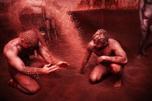 Kushti - Pehlwans (wrestlers) covering their body with red clay, Pune