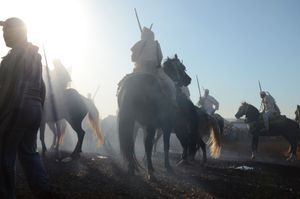 Riders in the smoke . Oulad Haddou, Bouskoura, Morocco