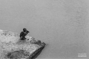 A man sitting by river's edge | Ahmedabad, Gujarat.