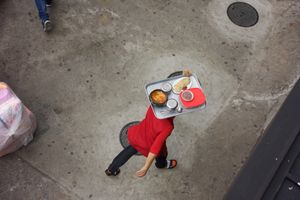 A lady delivering lunch on a tray.