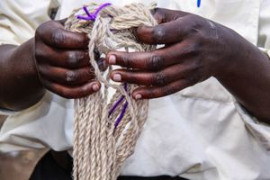 Man Holds Up Hand-Spun Yarn, Musanze Rwanda Africa