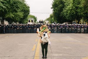 A solitary protester left the crowd of anti-government demonstrators to stand alone and face a line of police.