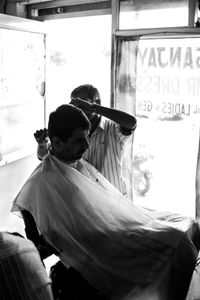 The Barber - The afternoon sun pours in as a customer gets a haircut.