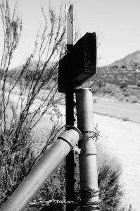 Behind "No trespassing" sign