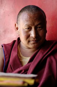 This monk is shown inside Drepung Monastery. Drepung sits high on a mountainside outside of Lhasa, Tibet. It was once the largest monastery in the world with 10,000 monks in residence. Today, about 700 live there. Photographed on 29 June 2005. © Forest McMullin