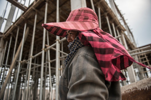Leng Puoek 40 has been working in construction for 3 years. She believes that "If something drops on my heads then that’s the will of the gods." Puoek has not been given a helmet so, by her own admission has to be very careful.