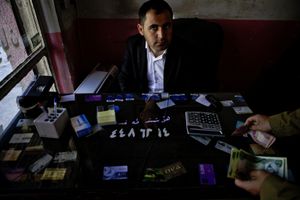 A currency trader in his office in Haj Omaran, a city next to the Iranian border. © Tom Verbruggen
