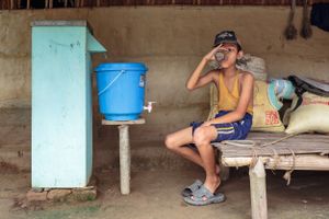 Ram Pokherai drinks clean water from his family's biosand filter