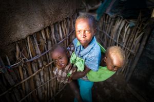 Samburu child taking care of his brothers