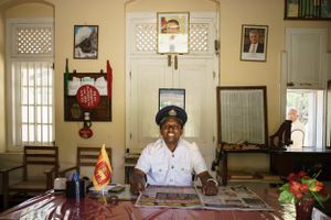 The smiling Station Master inside his office at a station on the Kandy to Badulla Railway Line in Sri Lanka.
