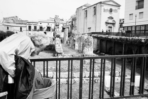 Man searching for something in the garbage near the Apollo Temple, Siracusa