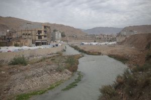General view of one of the districts next to the river. People camped beside their destroyed homes