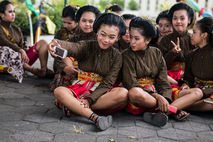 Participants take a selfie wearing traditional javanese outfits during the Bentara Upacara festival. Yogiakarta