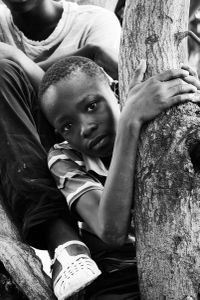 La fête du village - boys in trees and girls in the crowd, waiting for the spectacle to begin in a little village in Burkina Faso.