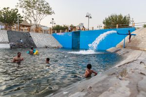 People from young boys to grown men enjoying the pool