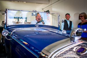Republican presidential candidate Gov. John Kasich of Ohio asks a member of his security detail if he can drive the 1930 Ford Model A Roadster downtown during a campaign stop in North Woodstock on Wednesday, Oct. 14, 2015.
