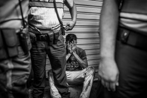A thief cries after being lynched by a crowd, ironically the police was on time to save him. The lack of responde of security forces has made people take the justice in their own hands.