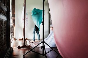 Girls praying during a fashion shoot.
