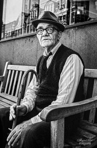 Man sitting on bend, Green Lanes, London