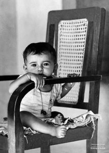 A young boy sitting in an old chair 01 | Dhanda, Punjab.