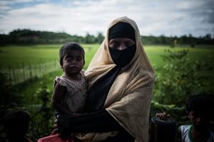 The Rohingya Refugee Crisis. A woman with her sick child on the road, in the middle of nowhere between different refugee camps, near Ukhia, Bangladesh.