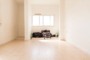 This is the empty flat of a Syrian family with all their belongings in Irbid. The family of five live in this unfurnished room since they arrived in Jordan and share the flat with relatives who also fled the war in Syria. So far they’ve survived on savings and now that they’re finally registered with UNHCR they will receive cash assistance and food vouchers. © David Brunetti