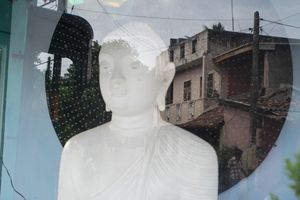 A buddha statue in a neighbourhood.