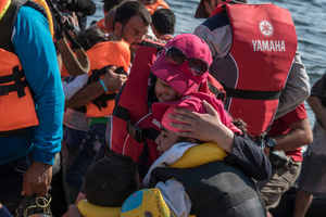 Families hug crying after reaching Lesvos. Thousands were landing every day on Lesvos island during 2015.