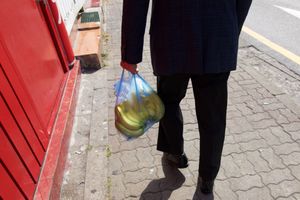 A man with a bag of bananas