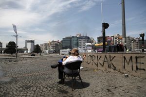 A protester takes a rest and observes the clashes between anti-government protesters and riot police in Taksim square in Istanbul, Turkey on Tuesday, June 11, 2013.