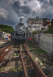 An abandoned steam locomotive still appears to be riding on the rails.