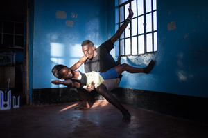 Kibera slum, Nairobi, KENYA, 06.11.2013: Quintor Adhiambo (17) and Victor Odhiimbo (19) at dance rehearsals of Waasani theatre group. Quintor left school in 7th grade after her father passed away. Her mother is unemployed and couldn't afford to further pay for her education. Through support from the group, which kept her away from bad company, she now attends a hairdressing course.
