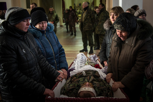 Family members mourn the body of a dead Separatist fighter at a mass funeral in the rebel-held town of Stakhanov, Eastern Ukraine.