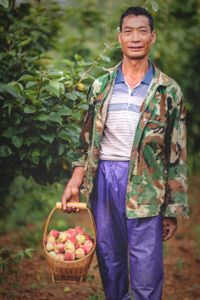 Xiong's leg was badly injured in an industrial accident at a factory. Support from the local Disabied Persons' Federation has allowed him to retrain as a farmer and provided the skills required to manage an orchard on his farm.