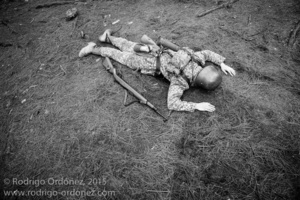 An Indonesian man dressed up as a German Waffen-SS soldier lies on the ground pretending to be dead during a gathering of re-enactment enthusiasts in Cibubur, East Jakarta, Indonesia.