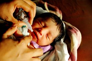 A day old infant is vaccinated in a nursing home in the slums of Antop Hill, Mumbai, Maharashtra