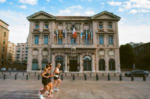 Joggers running by the City Hall.
