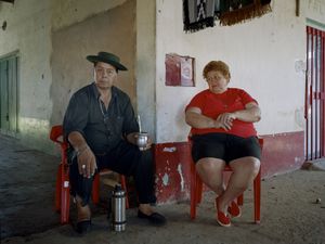 The custodians of the main temple of Gauchito Gil in Mercedes town, Corrientes. She wears the official red colour of the popular saint.