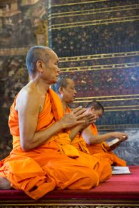 Bhikkhus (Buddhist monks) praying  in a temple in Thailand