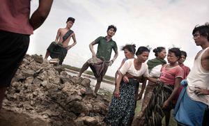 Sittwe, Myanmar, 2012. A mother buries her seventeen year old son in a hole near her home. He was shot the night before by the military, while out after curfew. His family have accused the military of taking bribes from the Rohingya to open fire on the Rakhine. © Spike Johnson