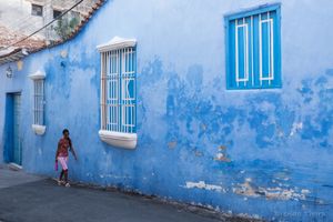 Blue alley and woman, Santiago de Cuba.
