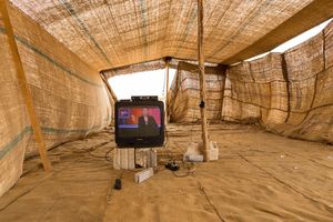 A telly in a make-shift tent. The families in this encampment have settle close to a food packaging plant where many of the adults are working illegally for low pay and the provision of water and electricity. The children, meanwhile, have little to occupy their time. None are in education and the TV offers them a little respite and distraction. © David Brunetti