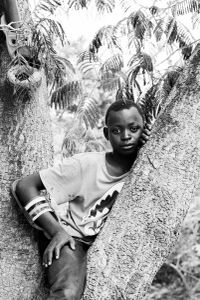 La fête du village - boys in trees and girls in the crowd, waiting for the spectacle to begin in a little village in Burkina Faso.
