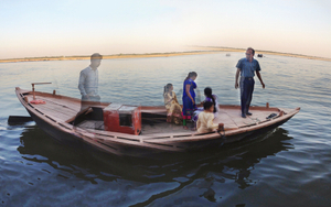 The river's movement gently rocks a tourist boat.