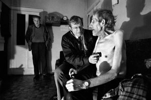 Dr Richard Dorman, from the Keady GP practice, Northern Ireland, listens to the chest of Tommy Martin in his home. 1998