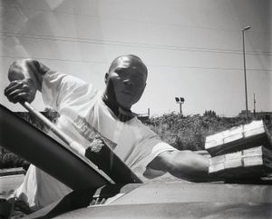 A tissue seller washes the windshield near the bypass road of Naples, 2015