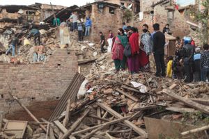 Neighbours from homes that were destroyed during the 2015 Nepal earthquake search for survivors and salvage belongings from the rubble.