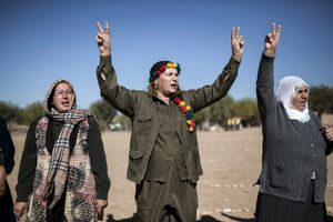 Kurdish people demonstrate in the southeastern border village of Mursitpinar, Sanliurfa province, Turkey near the Syrian town of Kobane, also known as Ain al-Arab on November 9, 2014,