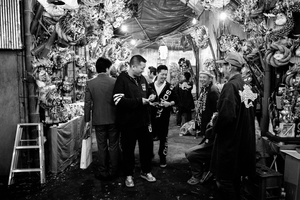 Two Yakuza talk with a man who work during a shinto festival in Hanazono shrine